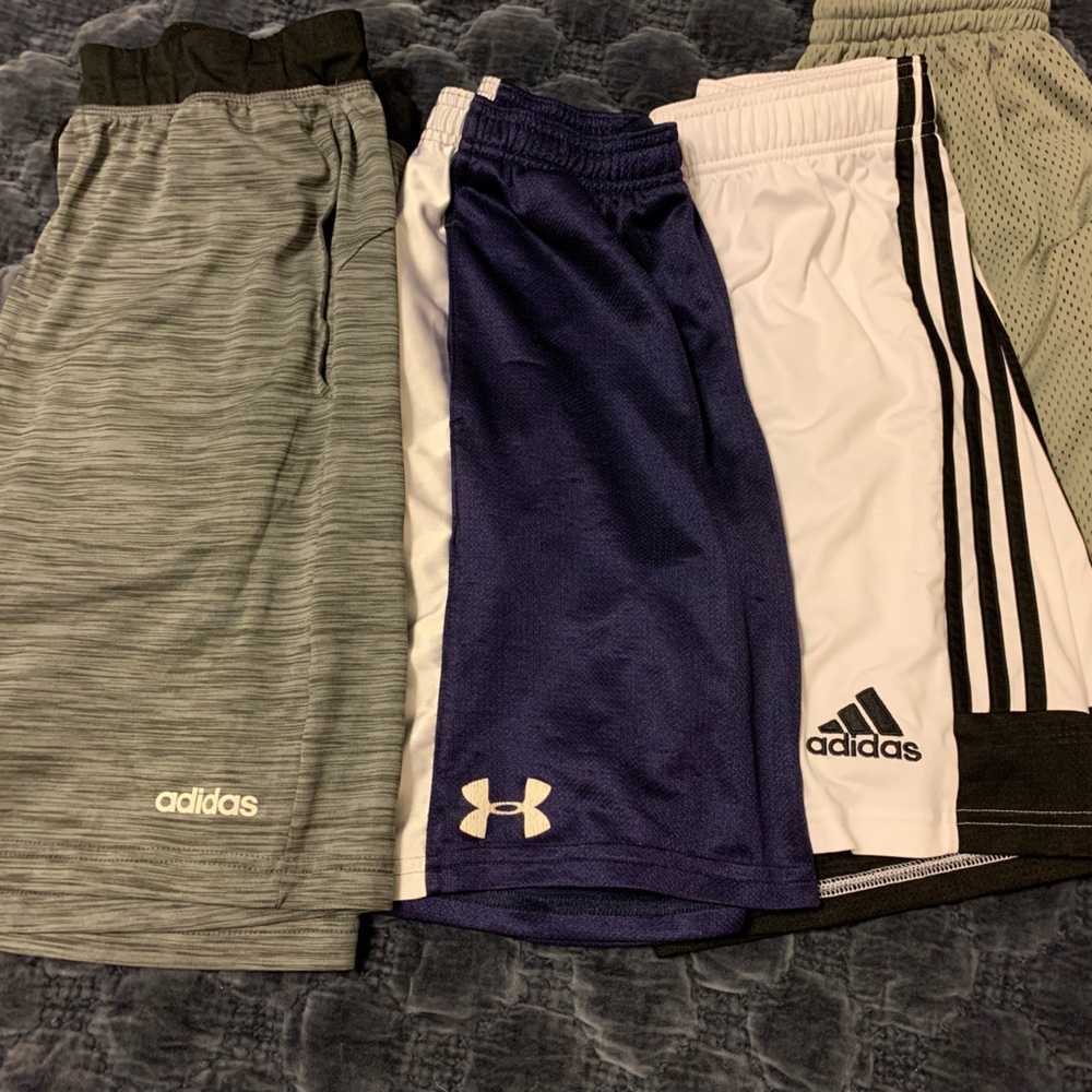 Adidas and under Armour lot, 4 pairs of youth medium athletic shorts.